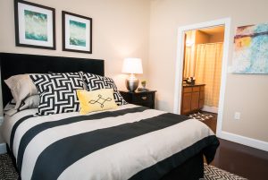 A black and white striped bed in a bedroom at Southgate Apartments in Baton Rouge.
