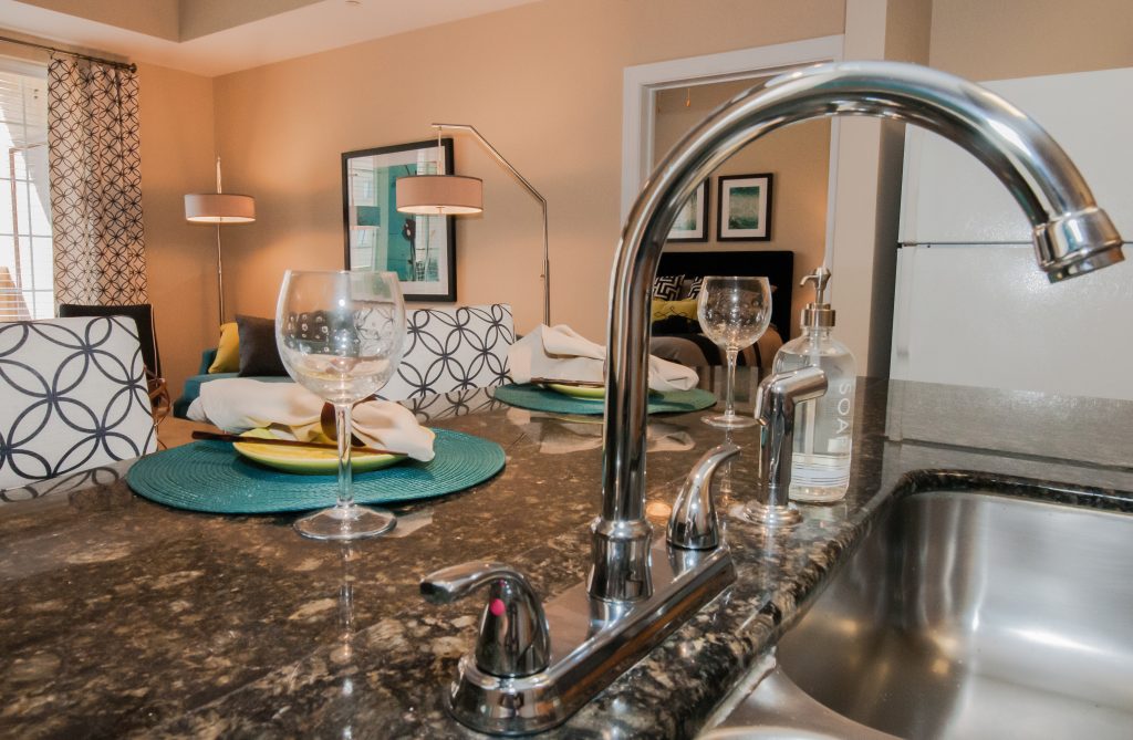 Southgate Apartments in Baton Rouge featuring a kitchen with a sink and wine glasses.