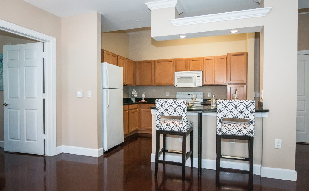 Southgate Apartments in Baton Rouge offer modern kitchens with beautiful wood floors and stylish bar stools.