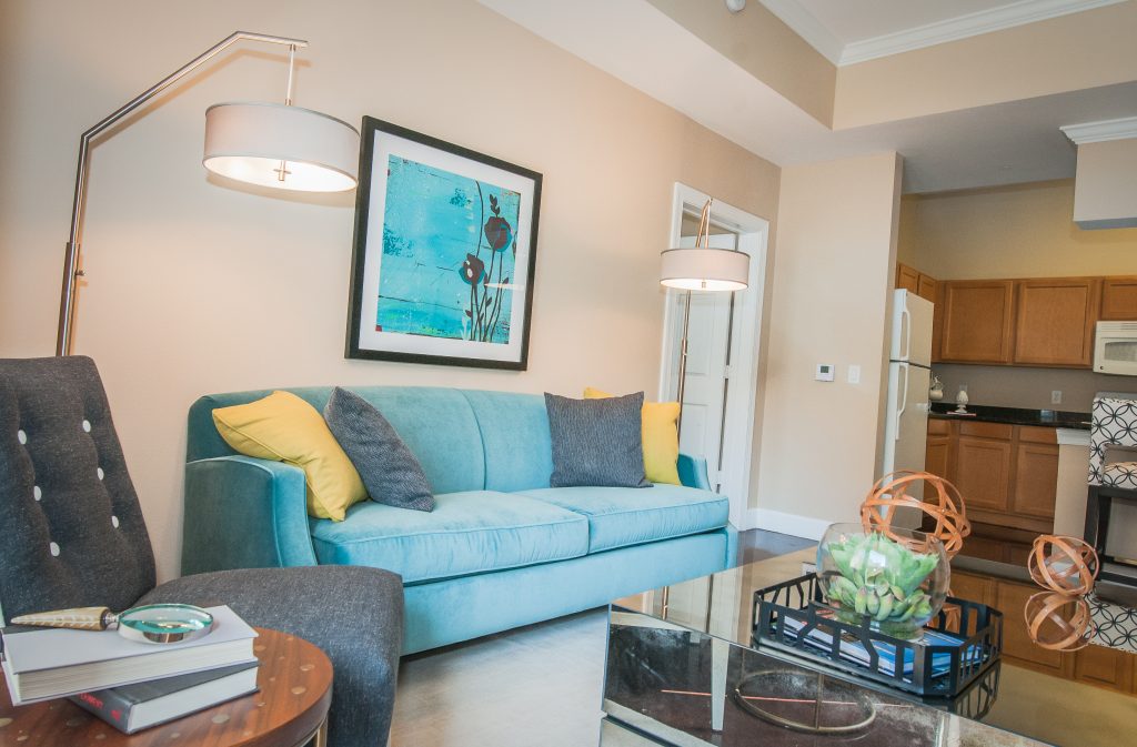 Southgate Apartments in Baton Rouge offers a stylish living room with a blue couch and coffee table.