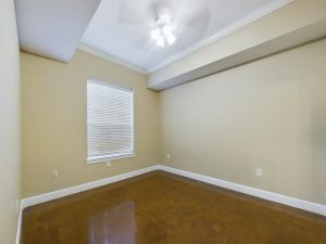 One Bedroom Apartments with a room featuring a ceiling fan and a window.